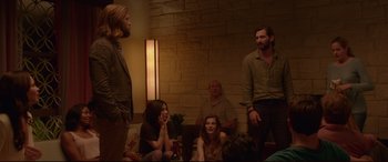 Movie still from “The Invitation” (2015), directed by Karyn Kusama – A group of people sitting in a living room next to each other; Medium shot, Over the shoulder angle