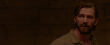 Movie still from “The Invitation” (2015), directed by Karyn Kusama – A man in a brown shirt is smoking a cigarette; Close Up shot, Over the shoulder angle