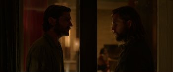 Movie still from “The Invitation” (2015), directed by Karyn Kusama – A man standing next to another man in front of a mirror; Medium shot, Over the shoulder angle