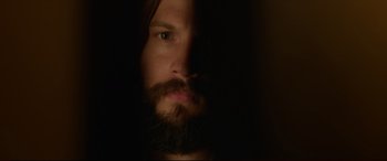 Movie still from “The Invitation” (2015), directed by Karyn Kusama – A man with a long beard is looking at the camera; Extreme Close Up shot, Low angle
