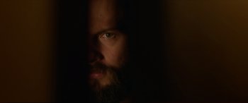 Movie still from “The Invitation” (2015), directed by Karyn Kusama – A man with a long beard is looking at the camera; Extreme Close Up shot, Low angle