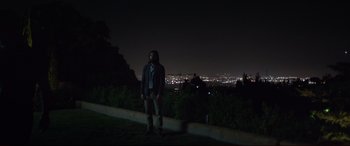 Movie still from “The Invitation” (2015), directed by Karyn Kusama – A man standing on top of a hill at night; Wide shot, Low angle