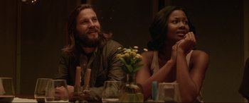 Movie still from “The Invitation” (2015), directed by Karyn Kusama – A man and a woman sitting at a dinner table; Medium shot, Over the shoulder angle