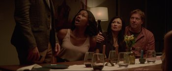 Movie still from “The Invitation” (2015), directed by Karyn Kusama – Two women sitting at a dinner table with wine glasses; Medium shot, Over the shoulder angle