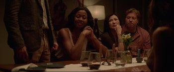 Movie still from “The Invitation” (2015), directed by Karyn Kusama – Two women are sitting at a table with wine glasses; Medium shot, Over the shoulder angle