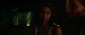 Movie still from “The Invitation” (2015), directed by Karyn Kusama – A beautiful young woman with long black hair; Close Up shot, Over the shoulder angle