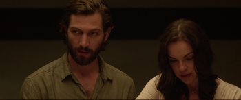 Movie still from “The Invitation” (2015), directed by Karyn Kusama – A man and a woman standing next to each other; Close Up shot, Over the shoulder angle