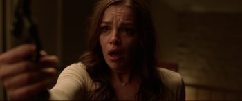 Movie still from “The Invitation” (2015), directed by Karyn Kusama – A person sitting down with her mouth wide open; Close Up shot, Over the shoulder angle