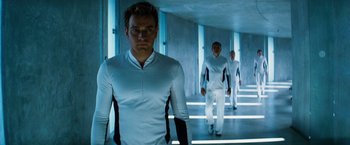Movie still from “The Island” (2005), directed by Michael Bay – A group of men walking down a hallway in a building; Medium shot, Low angle