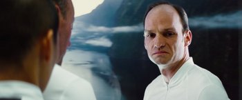 Movie still from “The Island” (2005), directed by Michael Bay – A man in a white shirt is looking at the camera; Close Up shot, Low angle