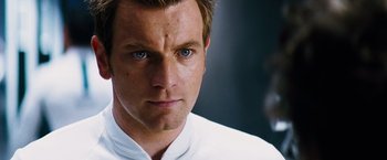 Movie still from “The Island” (2005), directed by Michael Bay – A person wearing a white shirt; Close Up shot, Over the shoulder angle