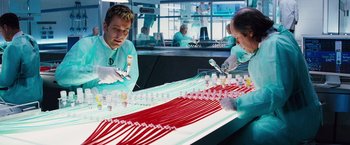 Movie still from “The Island” (2005), directed by Michael Bay – A man and a woman working in a lab; Medium shot, High angle
