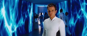 Movie still from “The Island” (2005), directed by Michael Bay – A man in a white shirt standing in a room; Medium shot, Over the shoulder angle