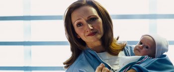 Movie still from “The Island” (2005), directed by Michael Bay – A person wearing a blue shirt; Close Up shot, Low angle