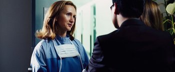 Movie still from “The Island” (2005), directed by Michael Bay – A woman in a blue gown and a man in a black suit; Close Up shot, Over the shoulder angle