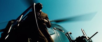 Movie still from “The Island” (2005), directed by Michael Bay – A man standing next to the door of a helicopter; Wide shot, Low angle