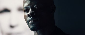 Movie still from “The Island” (2005), directed by Michael Bay – A man's face in the dark; Close Up shot, Low angle