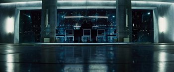 Movie still from “The Island” (2005), directed by Michael Bay – Two people are sitting at a bar at night; Wide shot, Low angle