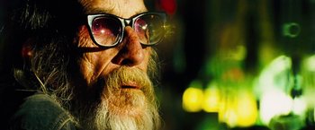Movie still from “The Island” (2005), directed by Michael Bay – An old man with a beard wearing glasses; Close Up shot, Low angle