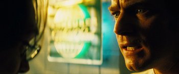 Movie still from “The Island” (2005), directed by Michael Bay – A man's face in front of a neon sign; Extreme Close Up shot, Over the shoulder angle