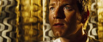 Movie still from “The Island” (2005), directed by Michael Bay – A man's face in front of a building; Close Up shot, Low angle