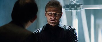 Movie still from “The Island” (2005), directed by Michael Bay – A man wearing glasses and a black shirt is talking to a woman; Close Up shot, Over the shoulder angle