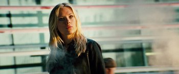 Movie still from “The Island” (2005), directed by Michael Bay – A woman with blonde hair is smoking a cigarette; Close Up shot, Low angle
