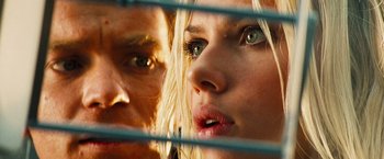 Movie still from “The Island” (2005), directed by Michael Bay – A man and a woman looking at each other through a fence; Extreme Close Up shot, Low angle