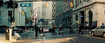 Movie still from “The Island” (2005), directed by Michael Bay – People crossing a busy city street with a police car; Extreme Wide shot, High angle