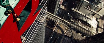 Movie still from “The Island” (2005), directed by Michael Bay – An aerial view of a city street with cars driving down the road; Extreme Wide shot, Overhead angle