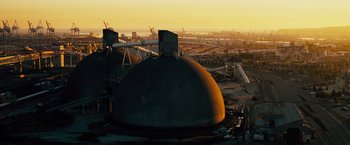 Movie still from “The Island” (2005), directed by Michael Bay – An aerial view of an industrial area at sunset; Extreme Wide shot, High angle