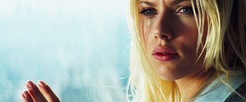 Movie still from “The Island” (2005), directed by Michael Bay – A person with long blonde hair; Close Up shot, Low angle