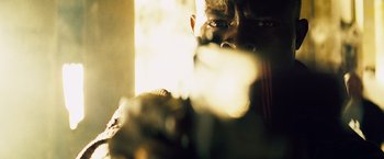 Movie still from “The Island” (2005), directed by Michael Bay – A person holding a gun; Extreme Close Up shot, Low angle