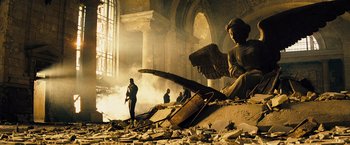 Movie still from “The Island” (2005), directed by Michael Bay – A group of people standing in a room with rubble; Wide shot, Low angle