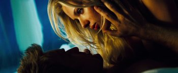 Movie still from “The Island” (2005), directed by Michael Bay – A woman with long blonde hair looking into the camera; Close Up shot, Low angle