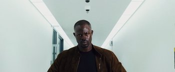 Movie still from “The Island” (2005), directed by Michael Bay – A man in a brown jacket standing in a hallway; Close Up shot, Low angle