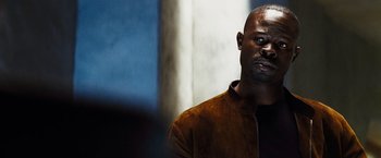 Movie still from “The Island” (2005), directed by Michael Bay – A man in a brown jacket is looking to his left; Close Up shot, Over the shoulder angle