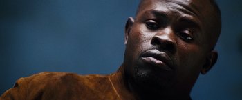 Movie still from “The Island” (2005), directed by Michael Bay – A man's face with a blue background; Close Up shot, Low angle