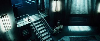 Movie still from “The Island” (2005), directed by Michael Bay – The stairs lead up to the second floor of the building; Wide shot, High angle