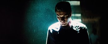 Movie still from “The Island” (2005), directed by Michael Bay – A man in a dark room with light shining on his face; Close Up shot, Low angle