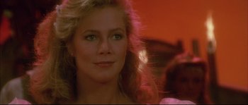 Movie still from “The Jewel of the Nile” (1985), directed by Lewis Teague – A woman's face in a red room; Close Up shot, Over the shoulder angle