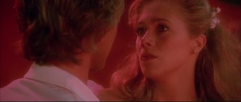 Movie still from “The Jewel of the Nile” (1985), directed by Lewis Teague – A young man and a young woman looking at one another; Close Up shot, Over the shoulder angle