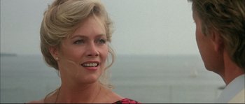 Movie still from “The Jewel of the Nile” (1985), directed by Lewis Teague – A person wearing a dress; Close Up shot, Over the shoulder angle