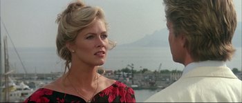 Movie still from “The Jewel of the Nile” (1985), directed by Lewis Teague – A woman is talking to a man on a pier; Close Up shot, Over the shoulder angle