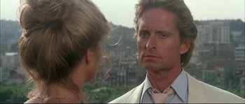 Movie still from “The Jewel of the Nile” (1985), directed by Lewis Teague – A man and a woman looking at one another in a mirror; Close Up shot, Over the shoulder angle