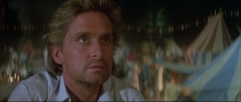 Movie still from “The Jewel of the Nile” (1985), directed by Lewis Teague – A person looking up at the sky; Close Up shot, Low angle