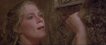Movie still from “The Jewel of the Nile” (1985), directed by Lewis Teague – A person looking at a mirror; Close Up shot, Low angle