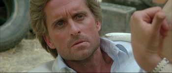 Movie still from “The Jewel of the Nile” (1985), directed by Lewis Teague – A person with long hair; Close Up shot, Low angle