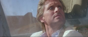 Movie still from “The Jewel of the Nile” (1985), directed by Lewis Teague – A person looking out a window; Close Up shot, Low angle