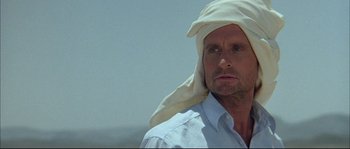 Movie still from “The Jewel of the Nile” (1985), directed by Lewis Teague – A person with a towel on his head; Close Up shot, Low angle
